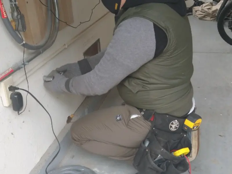 Electrician performing outlet wiring in a Wekiwa Springs garage